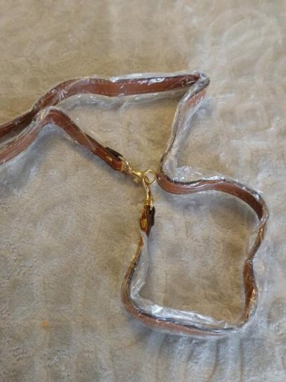 brown purse strap with gold hardware